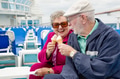 Happy Senior Adult Couple Enjoying Ice Cream On The Deck of a Luxury Passenger Cruise Ship. - PhotoDune Item for Sale
