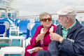 Happy Senior Adult Couple Enjoying Ice Cream On The Deck of a Luxury Passenger Cruise Ship. - PhotoDune Item for Sale