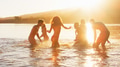 Group Of Young Friends In Swimwear Having Fun Splashing In Lake With Lens Flare - PhotoDune Item for Sale