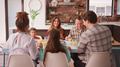 Multi Generation Family Enjoying Meal Around Table At Home - PhotoDune Item for Sale