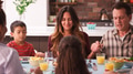 Multi Generation Family Praying Before Meal Around Table At Home - PhotoDune Item for Sale