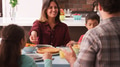 Family Enjoying Meal Sitting Around Table At Home Together - PhotoDune Item for Sale