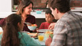 Family Enjoying Meal Sitting Around Table At Home Together - PhotoDune Item for Sale