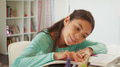 Young Girl Sitting At Desk In Bedroom Colouring In Picture - PhotoDune Item for Sale