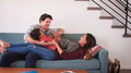 Family Shot With Parents Lying On Sofa And Playing With Son At Home - PhotoDune Item for Sale