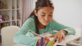 Young Girl Sitting At Desk In Bedroom Doing Homework - PhotoDune Item for Sale