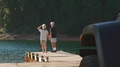Rear View Of Senior Couple On Road Trip In Convertible Car Standing On Wooden Jetty By Lake - PhotoDune Item for Sale