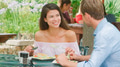 Mid Adult Couple Sitting At Table Enjoying Meal At Outdoor Cafe Or Restaurant - PhotoDune Item for Sale