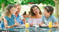 Family Sitting At Table Enjoying Snack At Outdoor Cafe Or Restaurant - PhotoDune Item for Sale