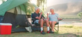 Senior Couple On Camping Trip In Countryside By Lake Relaxing With Drinks - PhotoDune Item for Sale