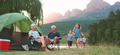Multi Generation Family On Camping Trip In Countryside By Lake Relaxing As Children Play - PhotoDune Item for Sale