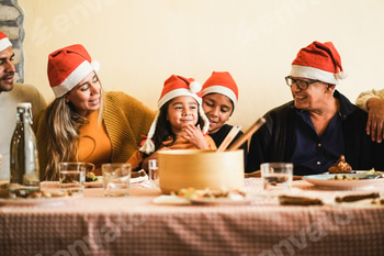 Happy latin family celebrating together during Christmas dinner - Focus on mother face