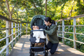 Hiking woman walk with baby stroller along trail - PhotoDune Item for Sale