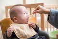 Little Baby Tries Solid Food for First Time with Spoon - PhotoDune Item for Sale