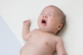Adorable newborn baby sneezing on soft mat - PhotoDune Item for Sale