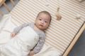 Curious baby looking at hanging toy in crib - PhotoDune Item for Sale