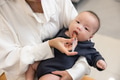 Mother feeding medicine with syringe to child - PhotoDune Item for Sale