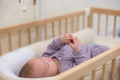 Newborn baby lying in crib sleeping - PhotoDune Item for Sale
