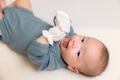 Infant baby with tiny mittens resting in nursery - PhotoDune Item for Sale
