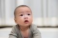 Cute baby looking up with curious expression - PhotoDune Item for Sale