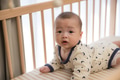 Baby flipping and crawling on bed - PhotoDune Item for Sale