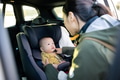 Mother adjusting baby car seat position - PhotoDune Item for Sale