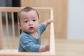 Happy baby learning to stand in crib - PhotoDune Item for Sale