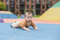 Baby crawling on colorful playground surface - PhotoDune Item for Sale