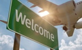 Welcome Green Road Sign with Airplane Above. - PhotoDune Item for Sale