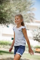 Joyful Girl with a Striped Top Happily Walking Outdoors. - PhotoDune Item for Sale