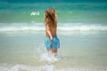 Joyful child is playing in the waves on a beautiful sunny beach - PhotoDune Item for Sale