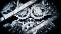 Metallic gears and chains rotating on black background - PhotoDune Item for Sale