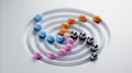 Colorful spheres rolling towards center of concentric circles, abstract concept - PhotoDune Item for Sale