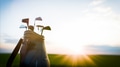 Golf clubs resting in bag at sunset on course - PhotoDune Item for Sale