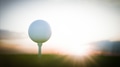 Golf ball on tee at sunset awaits the perfect drive - PhotoDune Item for Sale