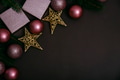 Pink christmas balls on brown background top view. Shiny christmas baubles, present box and fir tree - PhotoDune Item for Sale