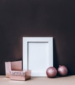 Empty photo frame on brown wall with pink christmas decoration. Styled winter holiday - PhotoDune Item for Sale