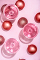 Pink champagne in luxury crystal glasses and christmas baubles. Top view. New year eve celebration - PhotoDune Item for Sale