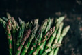 Fresh asparagus on rustic black kitchen table from above. Organic green vegetable on vintage board. - PhotoDune Item for Sale