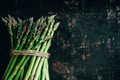 Fresh asparagus on rustic black kitchen table. Superfood cooking recipe. Organic vegetable - PhotoDune Item for Sale