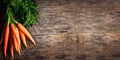 Top view of fresh organic carrot roots on wooden textured background - PhotoDune Item for Sale