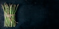 Food background with Fresh asparagus on rustic black kitchen table from above. Growing bio food - PhotoDune Item for Sale
