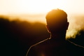 Silhouette of man smoking and watching the orange sun set - PhotoDune Item for Sale