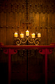 Candles burning on table in front of old rustic door - PhotoDune Item for Sale