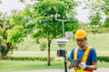 Man working collecting Air pollution, Weather monitor, Wind information data from sensor station - PhotoDune Item for Sale