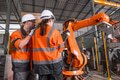 Robotic technician engineer male training helping young women team control operate robot welding arm - PhotoDune Item for Sale