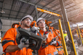 Robotic technician engineer male training helping young women team control operate robot welding arm - PhotoDune Item for Sale