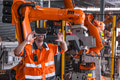 Engineer male using VR headset device to control operate robot arm in modern technology industry - PhotoDune Item for Sale