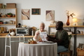 Senior Caucasian Woman Discussing Financial Documents with Young Black Man - PhotoDune Item for Sale