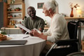 Black Man Explaining Documents to Senior Caucasian Woman with Disability - PhotoDune Item for Sale